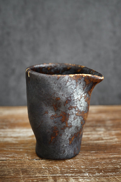 Rustic stoneware pouring jar with dark textured glaze, ideal for chefs. Holds 400ml of sauces, broths, and gravies, and pours cleanly