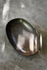 Bronze ceramic family sharing dish styled with stir-fried vegetables on a dinner table