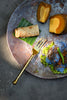 Polished stainless steel dessert fork with twisted hammered handle, top view