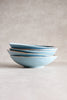 A stack of four light blue ceramic bowls with a speckled glaze and a thin brown rim.  Bowl Plates on sale In Singapore