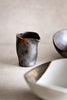 Close-up of the Charcoal Grill Pouring Jar — textured charcoal-and-caramel ceramic with a clean-pour spout for sauces and dressings
