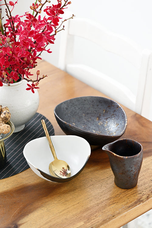 The Intimate Table set styled on a wood dining table with orchids — handcrafted ceramic dining set for couples and small families