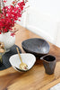 The Intimate Table set styled on a wood dining table with orchids — handcrafted ceramic dining set for couples and small families