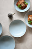 light blue speckled ceramic plate bowls on a neutral beige surface, handmade durable stoneware ships in Singapore