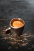 Wok Hei flat-handle ceramic espresso cup in charcoal with swirling brushstroke, three-quarter view