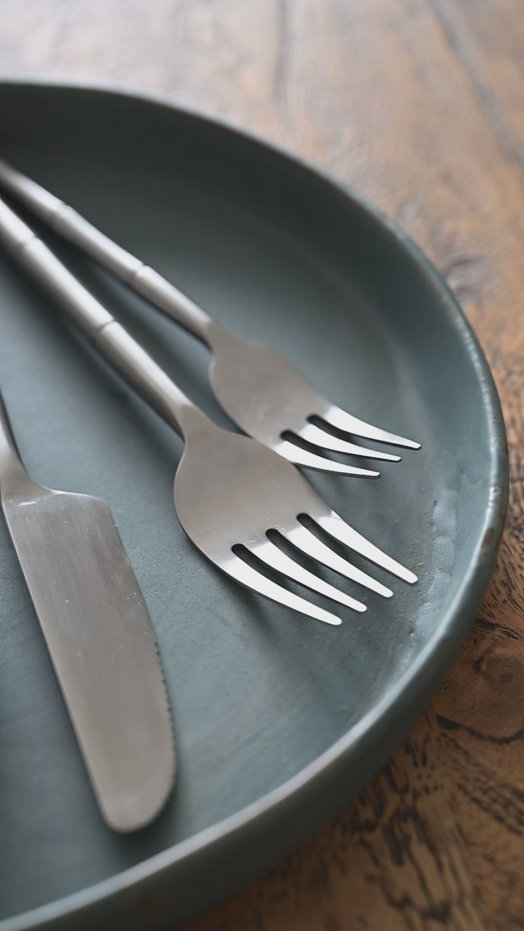 Hand-forged brushed steel cutlery set with sculpted segmented handles — Kra Sanctuary